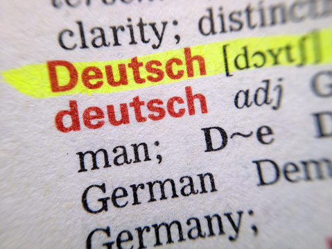 Closeup of the word German, highlighted on a dictionary page